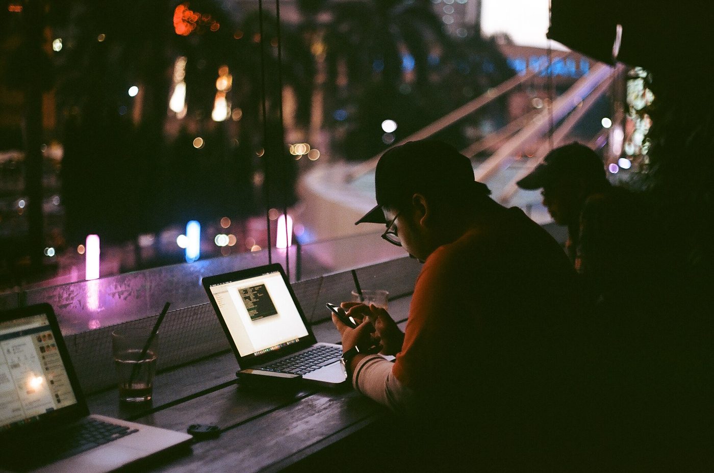 Freelancer working late at a laptop with warm desk lighting